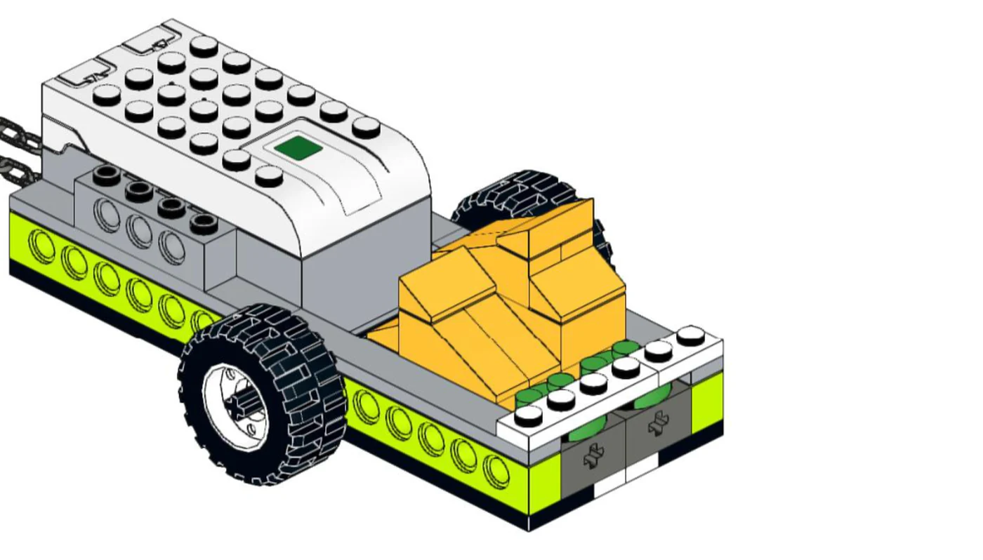 Одноосный прицеп из WeDo 2.0: на раме стоит белый смарт-хаб, рядом два оранжевых тюка сена, слева уходят цепи к тягачу